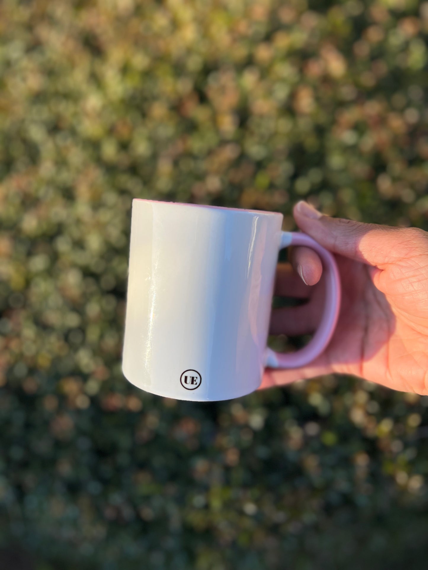 This image shows the back of the 11oz white ceramic mug with pink handle.