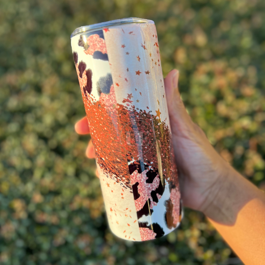 A 20oz fatty stainless steel tumbler with red stars, sparkles, and cheetah prints.  This tumbler includes a silicone bottom, leakproof top, metal straw and straw cleaner. Back view.