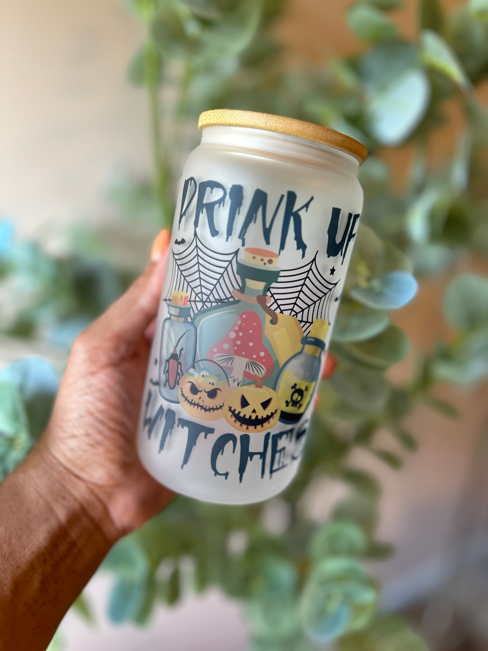Front Drink Up Witches 16oz glass can with spider webs, pumpkins and bottles